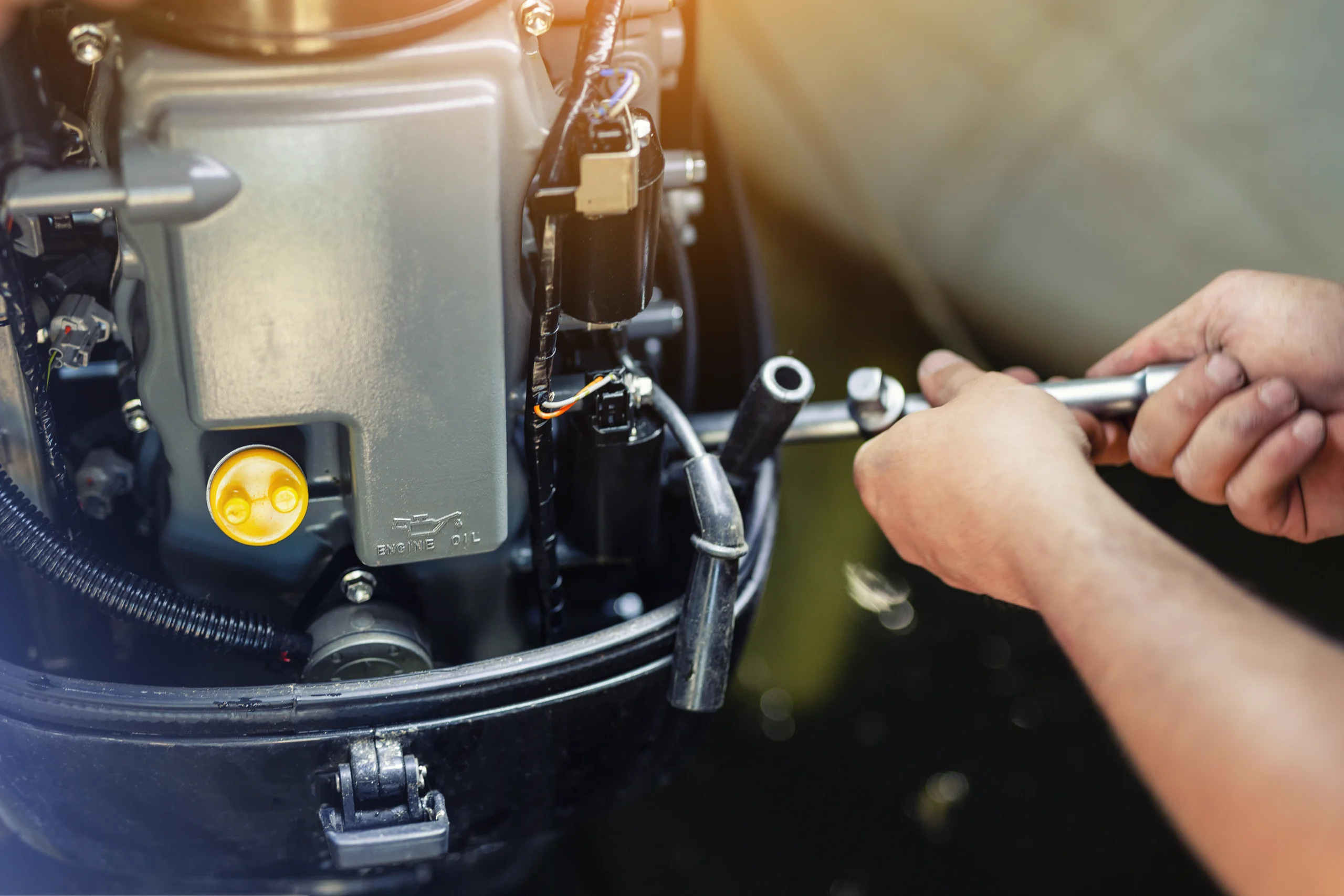 Image of Marcus Shubert, Master Marine Mechanic, repairing a boats engine room equipment.