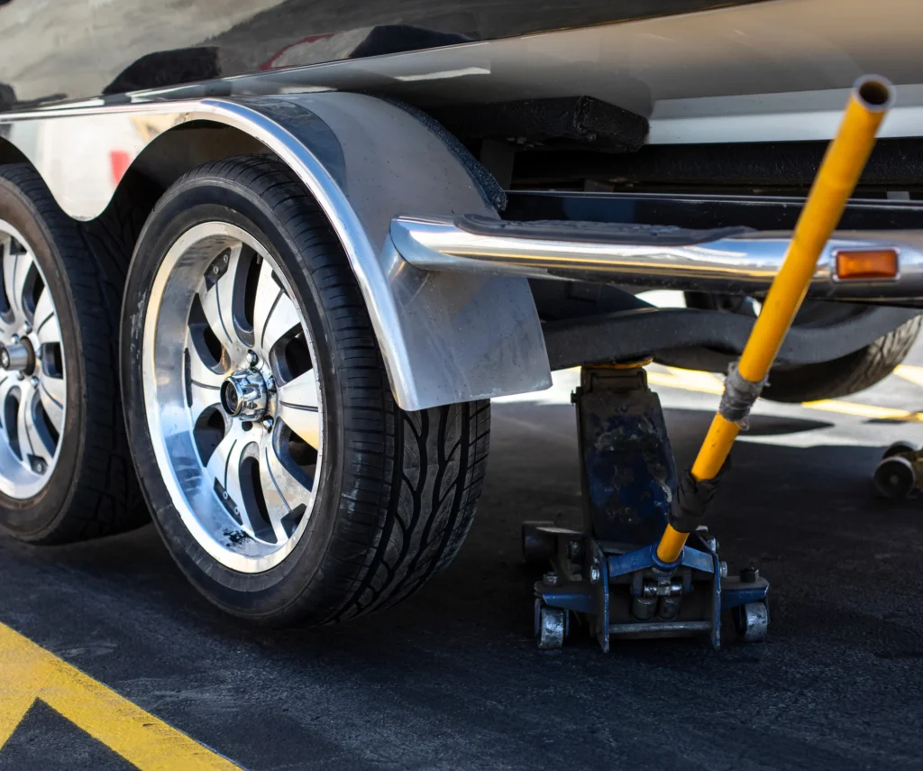 Image of a boat trailer sitting on a floor jack