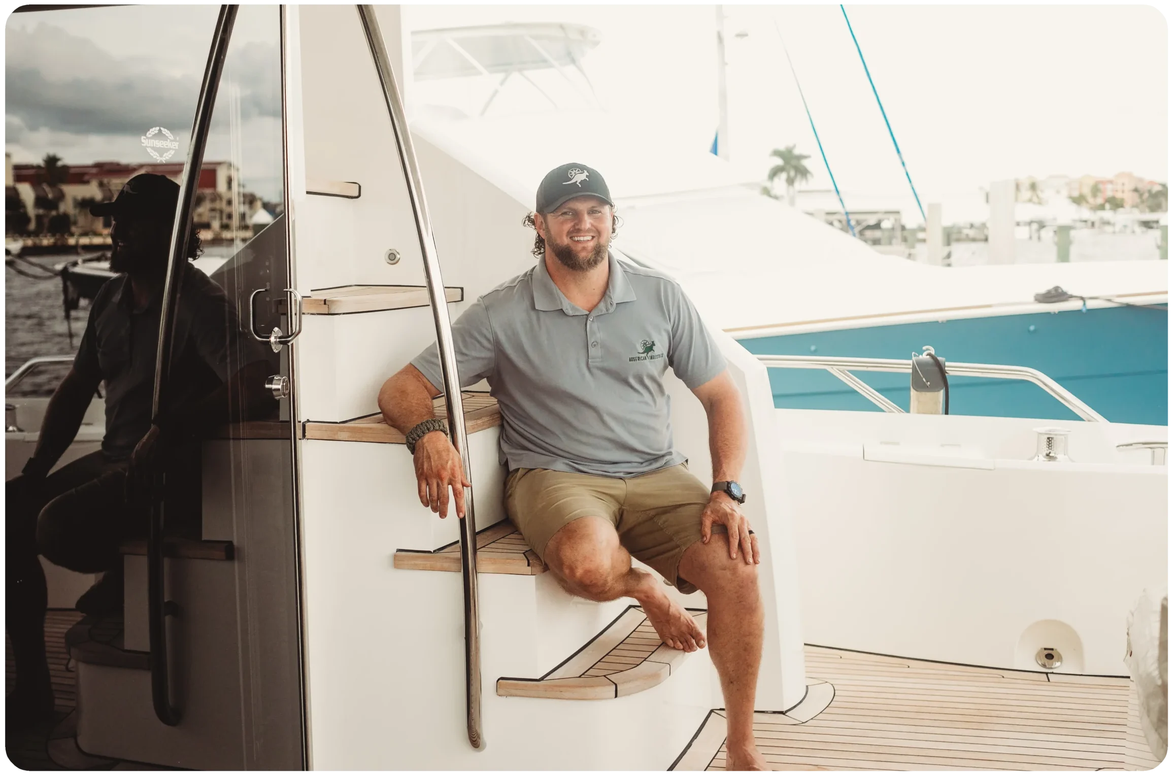 Image of Marcus Shubert posing on the deck of his personal boat in Naples